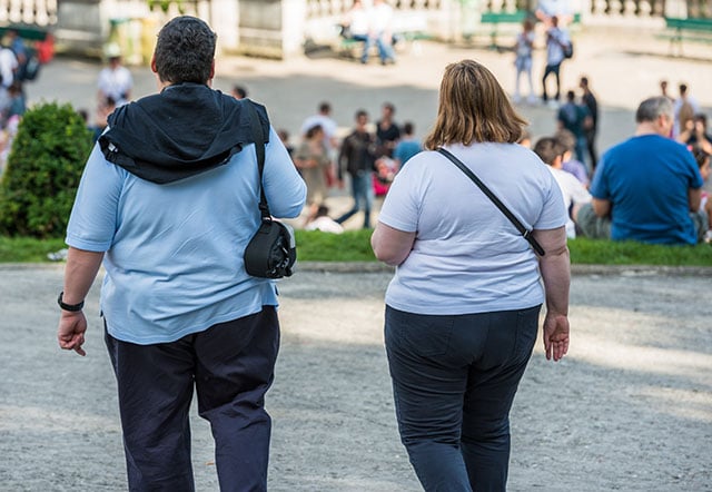 bese couple walking in a park in Paris